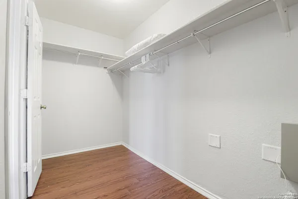 a view of a room with wooden floor