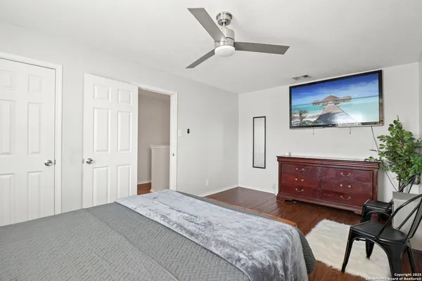 a bedroom with a bed and a painting on the wall