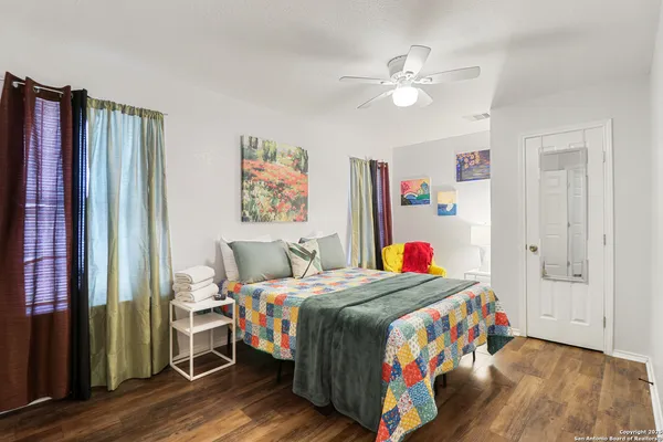 a room with a bed a dresser and book shelf