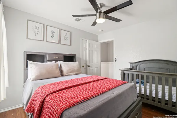 a bedroom with a large bed and a chandelier
