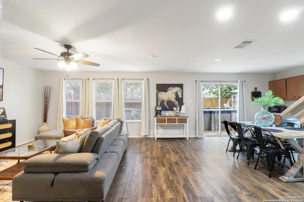 a living room with furniture and wooden floor