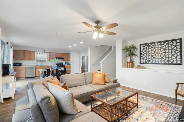 a living room with furniture and wooden floor