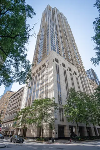 a view of a tall building next to a road