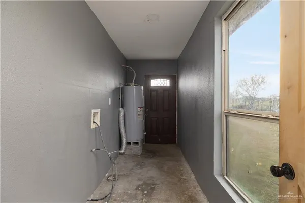 a view of a hallway with wooden shelves