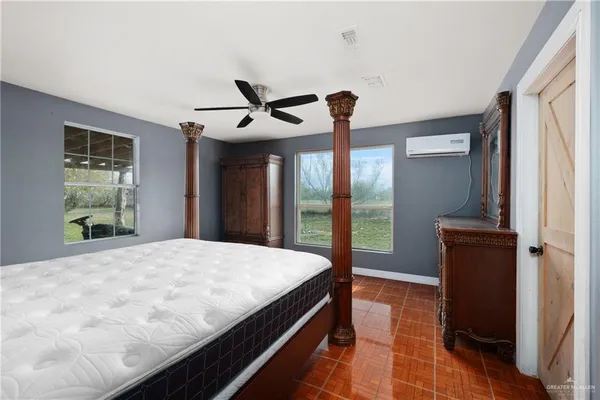 a bedroom with a bed and a chandelier