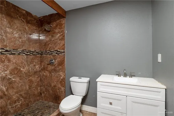 a bathroom with a toilet a sink and shower