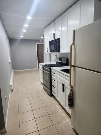 a kitchen with stainless steel appliances a refrigerator sink and microwave