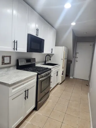 a kitchen with cabinets and steel stainless steel appliances