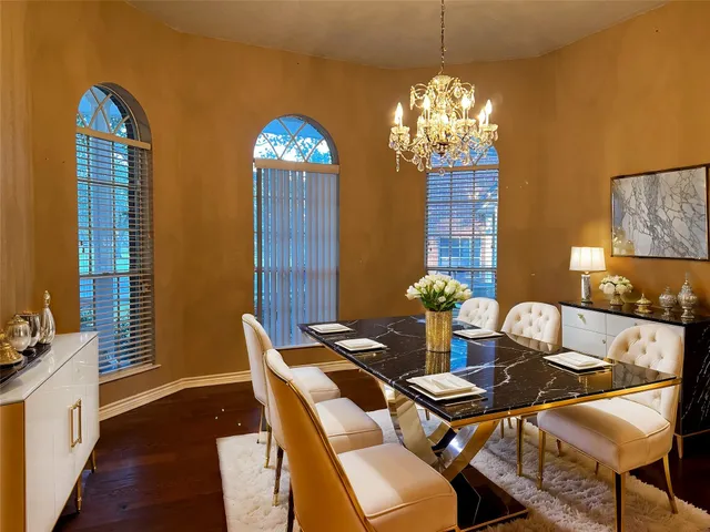 a view of a dining room with furniture and chandelier