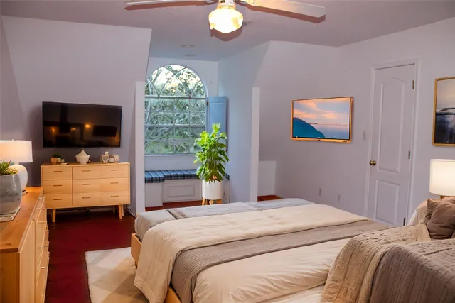 a bedroom with a bed and a television