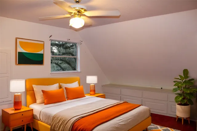 a bedroom with a bed and a potted plant