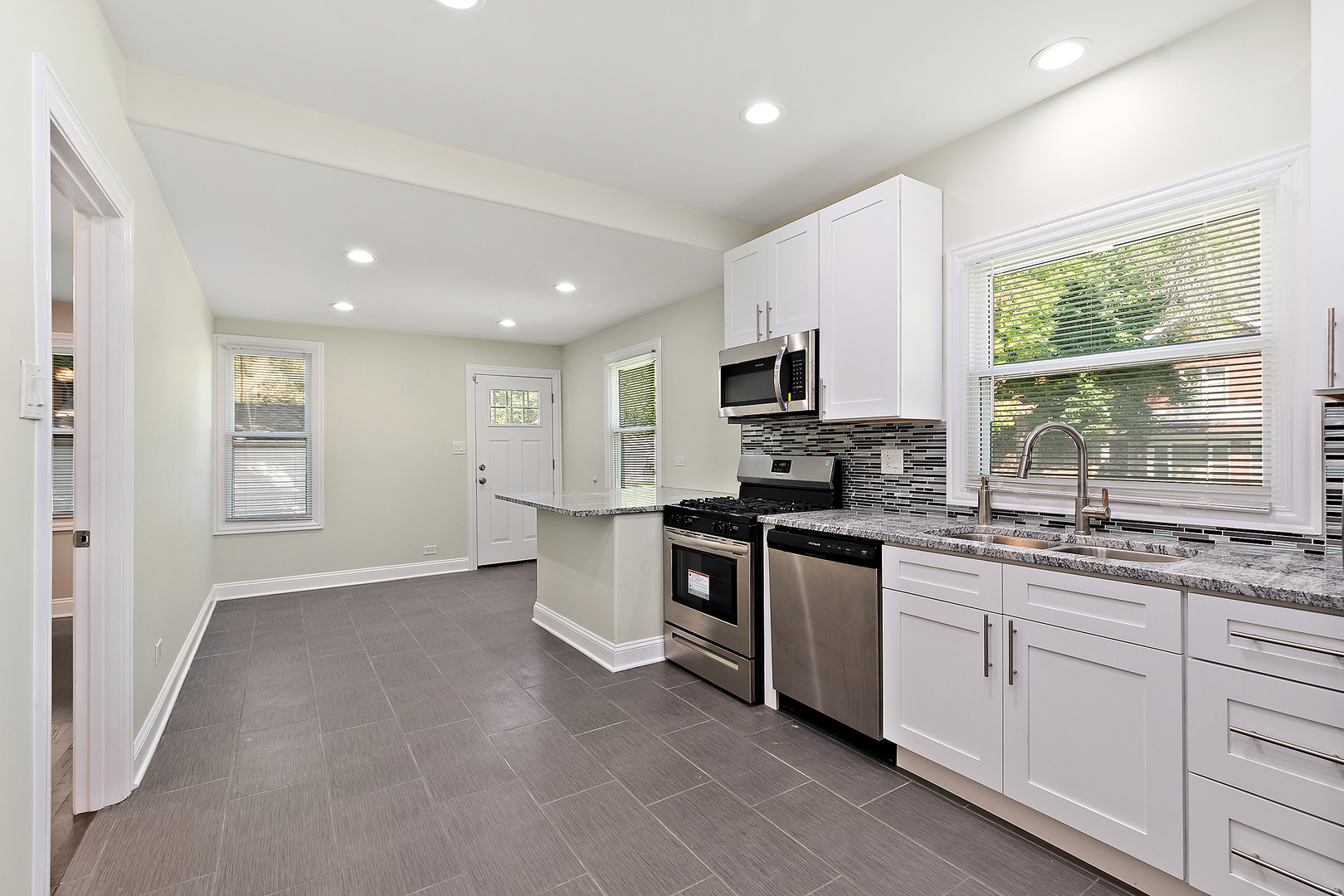 9400 South Charles Street Chicago, IL 60643 - Photo 7 of 30 a kitchen with granite countertop white cabinets a sink a window and stainless steel appliances
