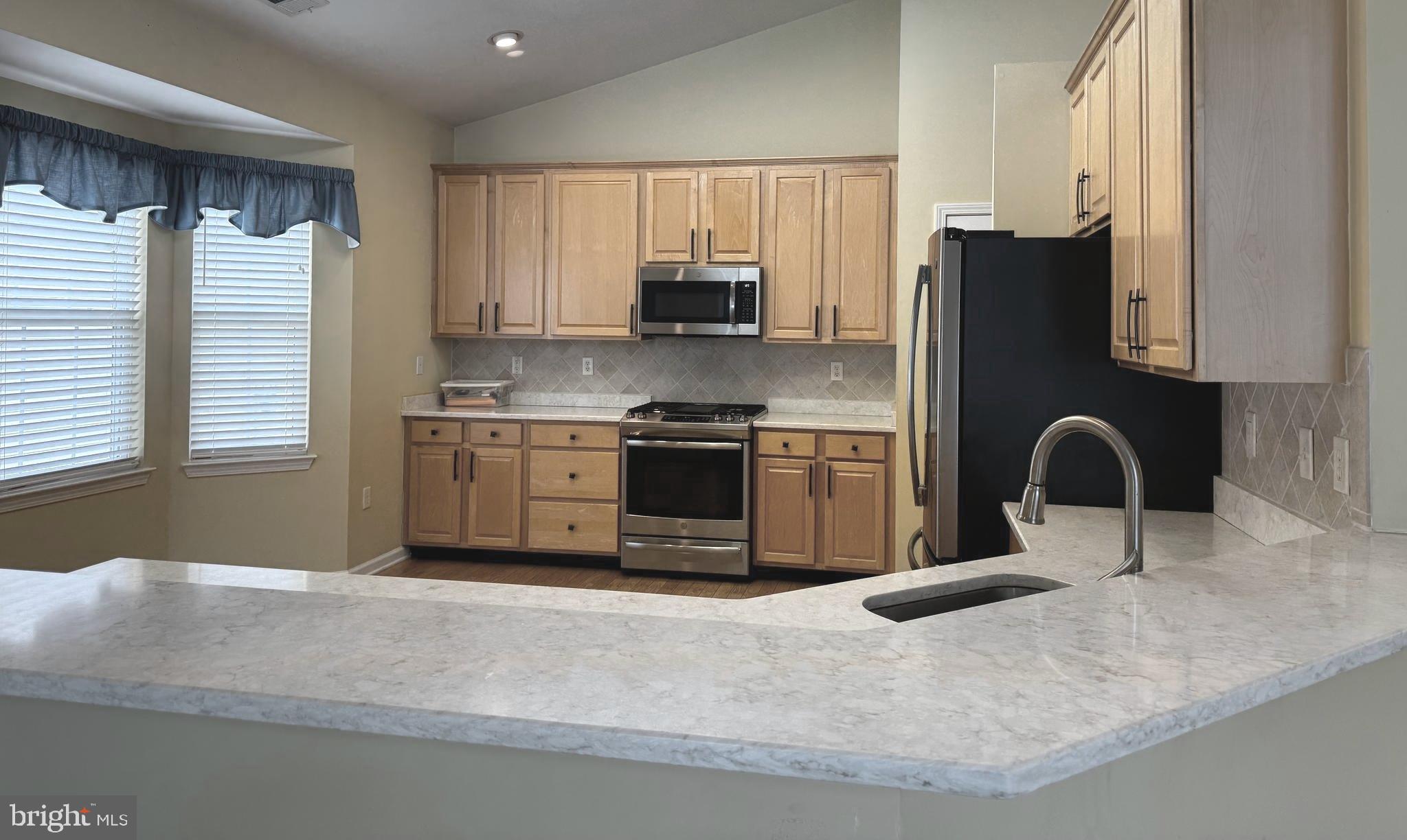 10 Powderhorn Way Allentown, NJ 08501 - Photo 12 of 42 a kitchen with stainless steel appliances granite countertop a stove a sink and a microwave