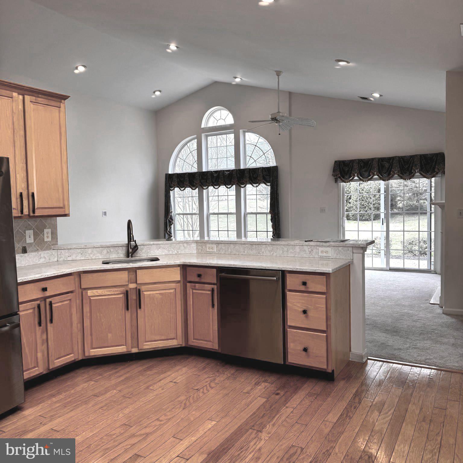 10 Powderhorn Way Allentown, NJ 08501 - Photo 14 of 42 a large kitchen with granite countertop a large window and cabinets