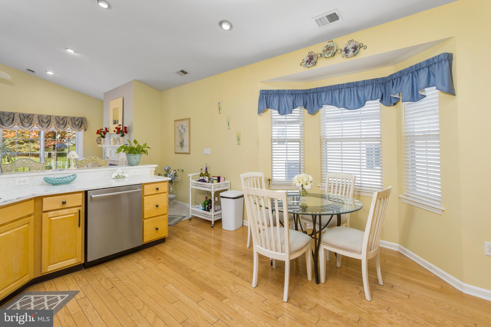 10 Powderhorn Way Allentown, NJ 08501 - Photo 15 of 44 a kitchen with a table chairs sink and cabinets