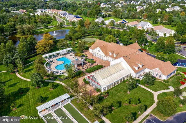 an aerial view of residential house with outdoor space and trees all around