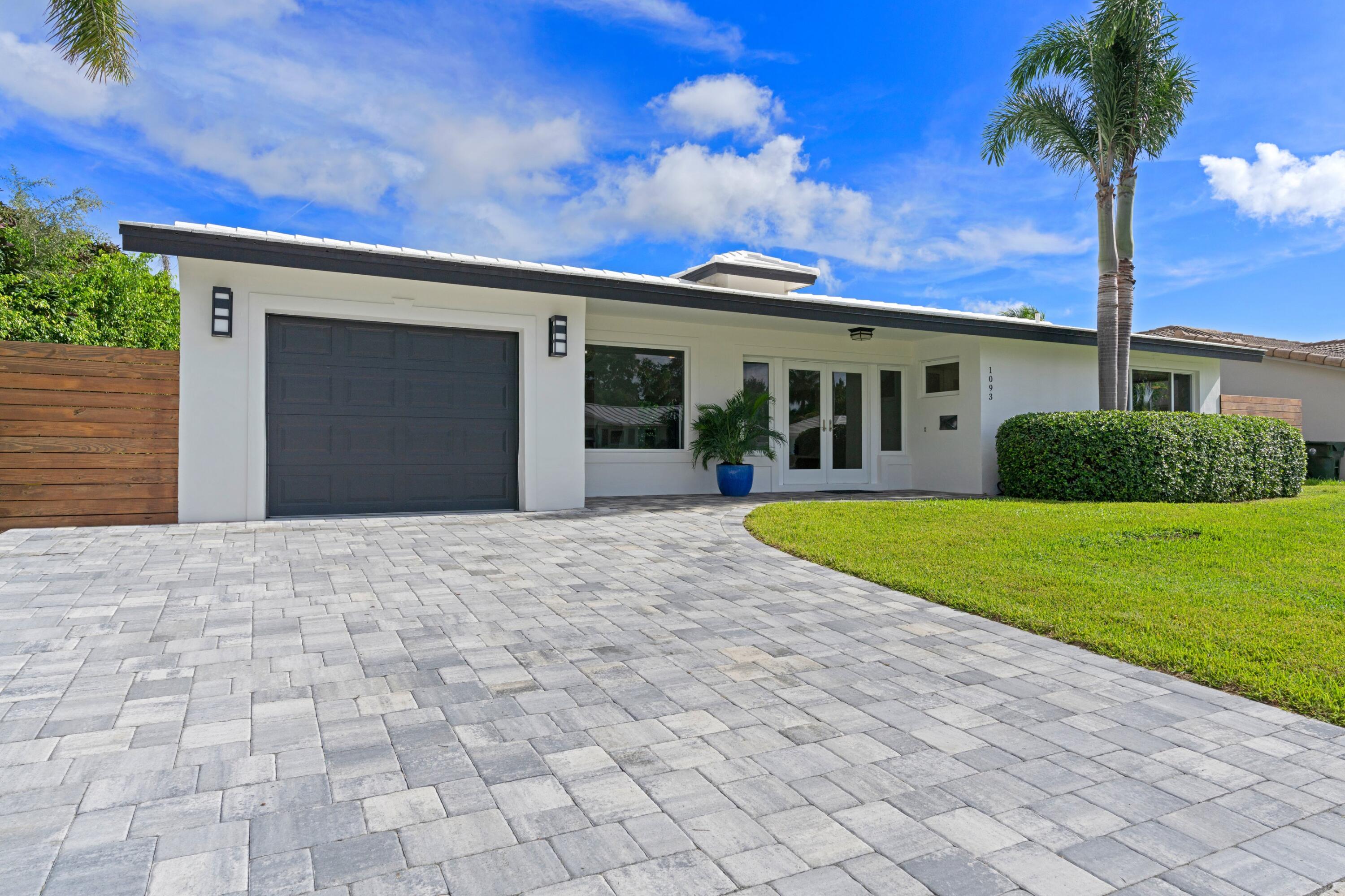 1093 Southwest 14th Street Boca Raton, FL 33486 - Photo 2 of 18 a view of a house with a yard and potted plants