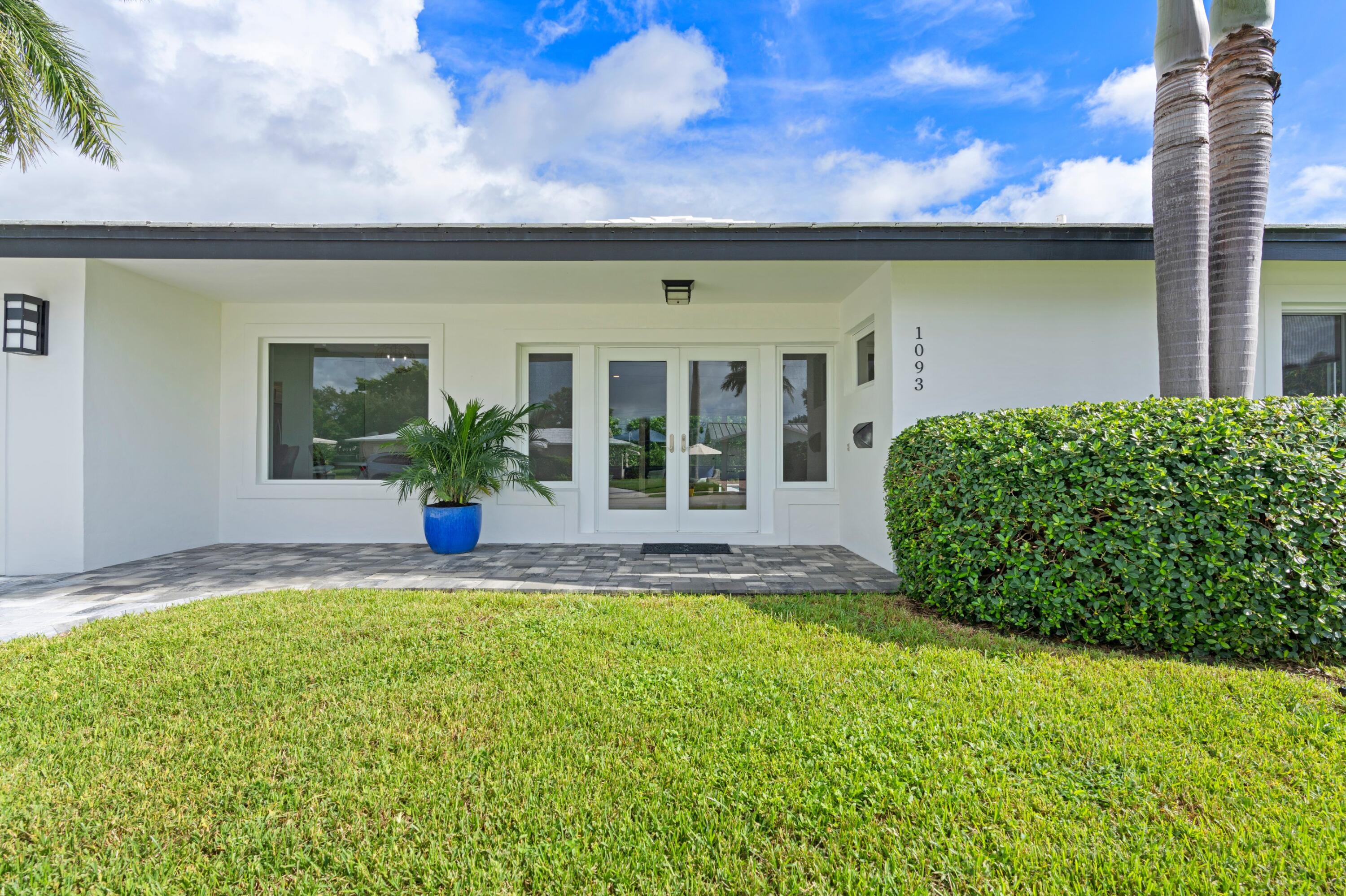1093 Southwest 14th Street Boca Raton, FL 33486 - Photo 4 of 18 a view of a house with a garden