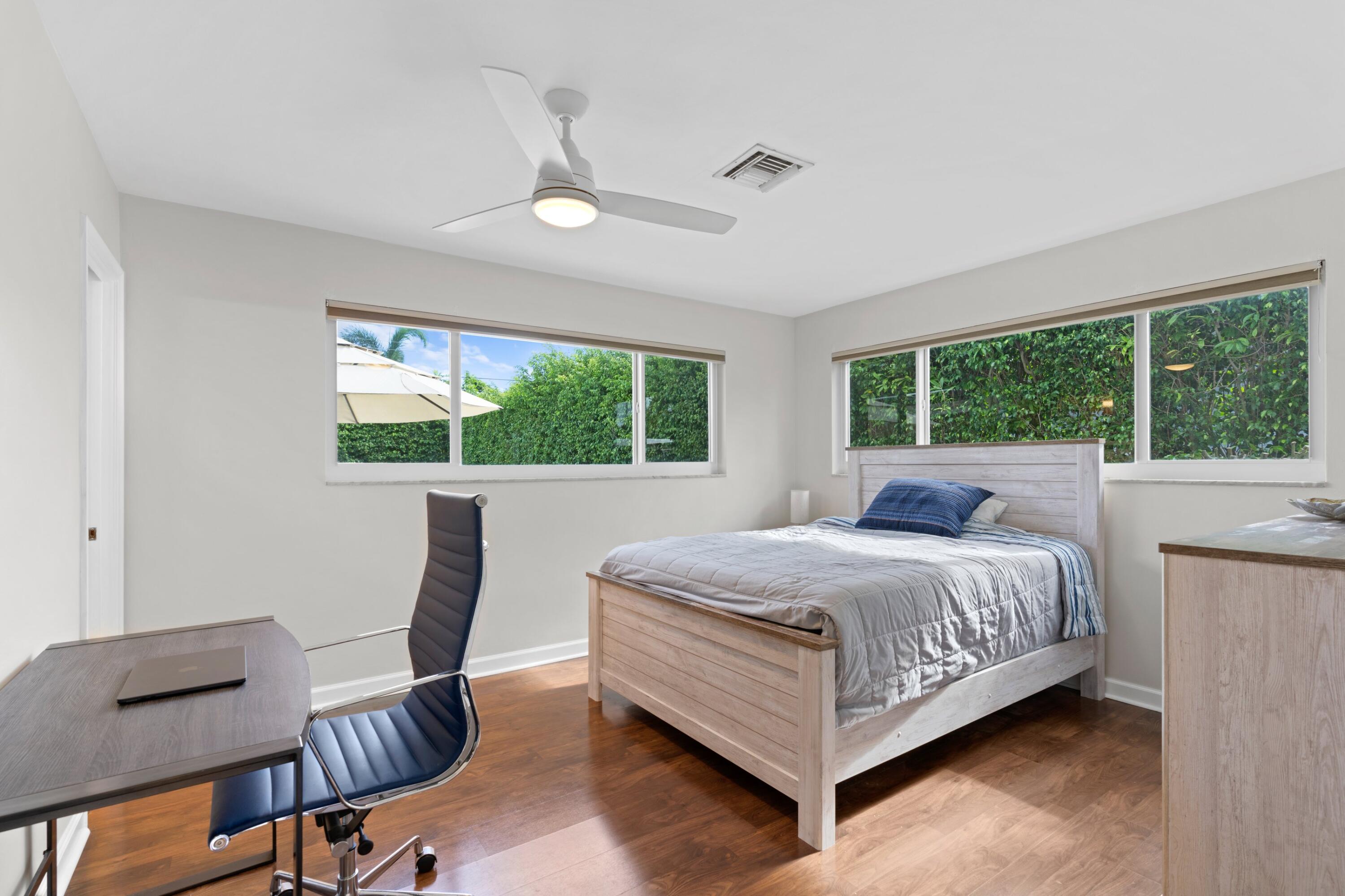 1093 Southwest 14th Street Boca Raton, FL 33486 - Photo 9 of 18 a bedroom with a bed and large windows