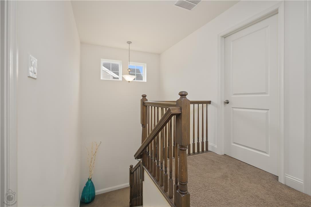 640 Rinaldi Lane Easton, PA 18040 - Photo 22 of 42 A warm landing features a robust wood railing, leading to bright upper windows and comfortable carpeting.