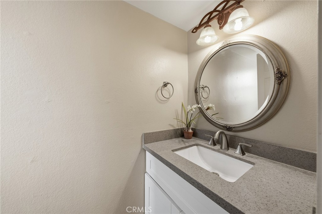 259 Scenic Way Brea, CA 92821 - Photo 21 of 62 a bathroom with a granite countertop double vanity and a mirror
