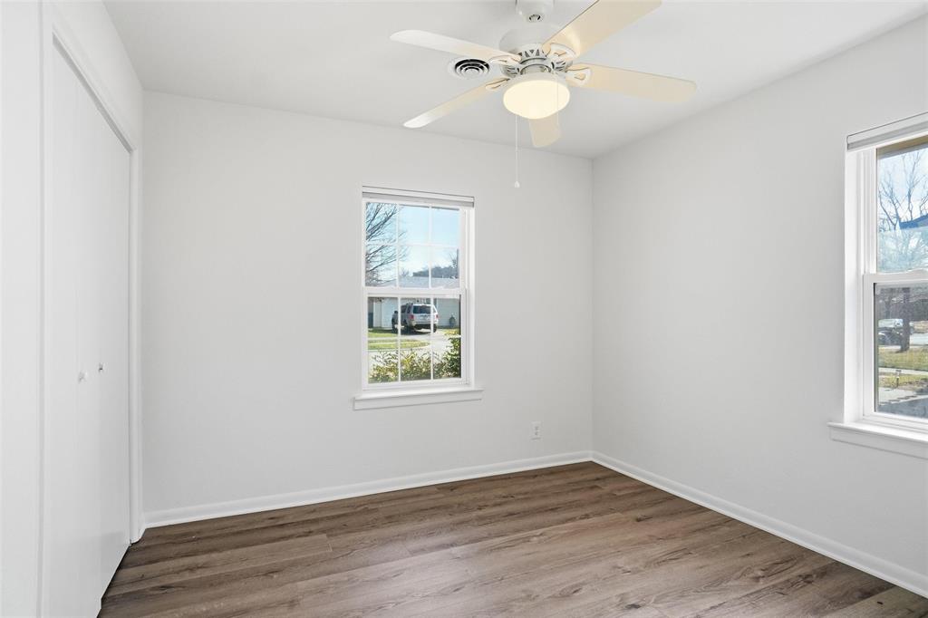 1236 Terrace Drive Grapevine, TX 76051 - Photo 18 of 25 an empty room with wooden floor fan and windows