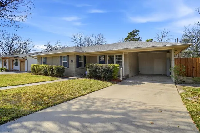 a view of a white house with a yard
