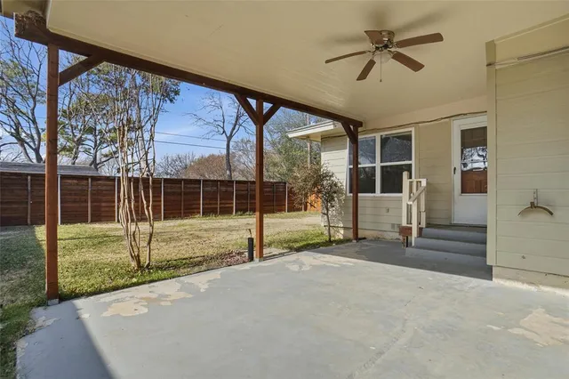 a view of empty room with wooden floor and fence