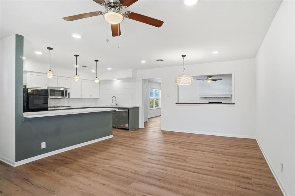 1236 Terrace Drive Grapevine, TX 76051 - Photo 5 of 25 a kitchen with stainless steel appliances granite countertop a refrigerator a sink a stove and a wooden floors