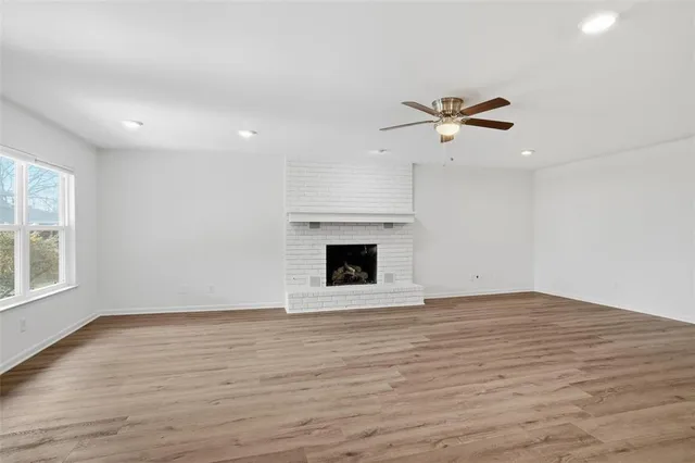 an empty room with fan and windows