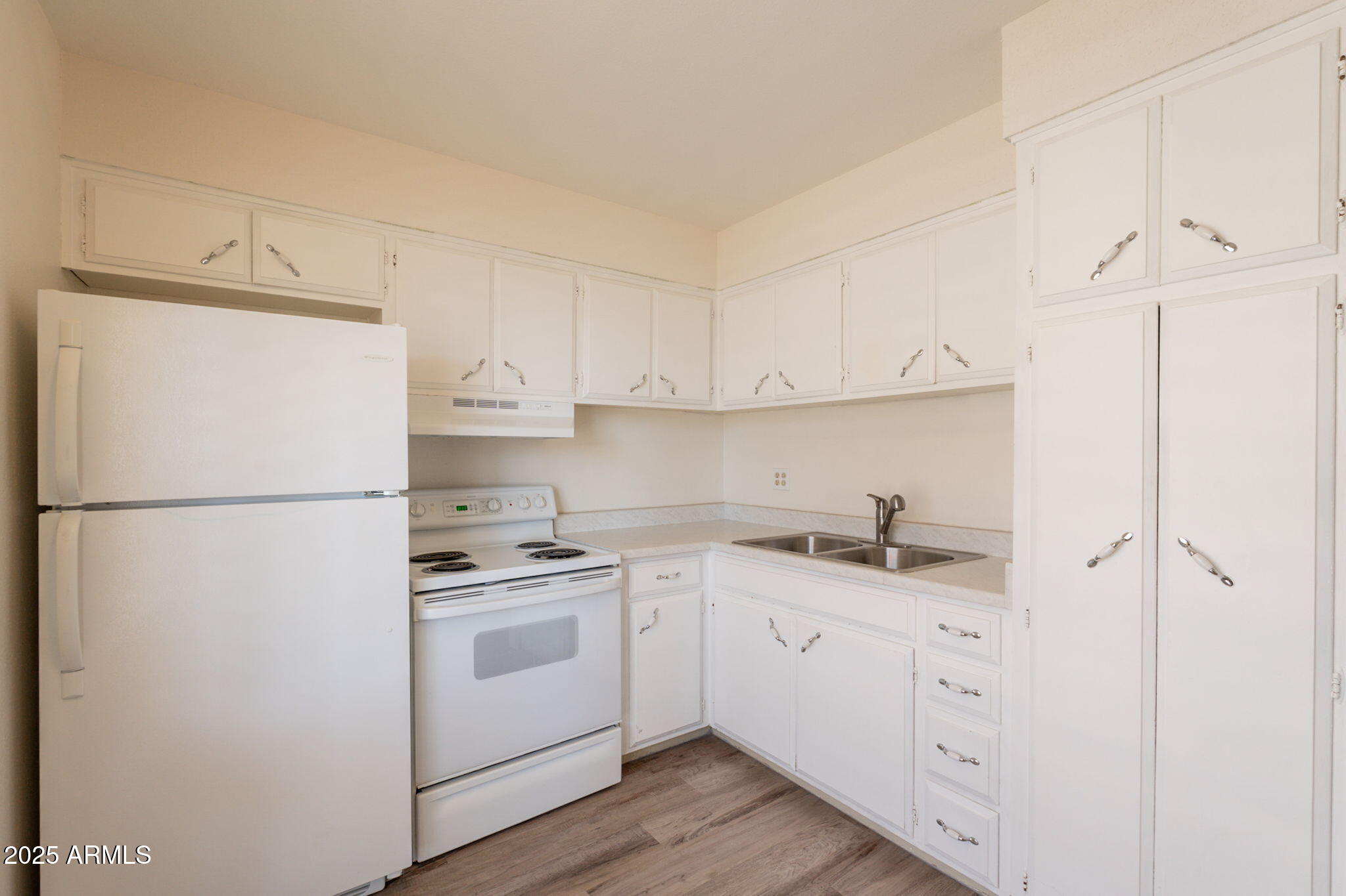 13001 North 113th Avenue, Unit 5 Youngtown, AZ 85363 - Photo 13 of 36 a kitchen with appliances a sink and cabinets