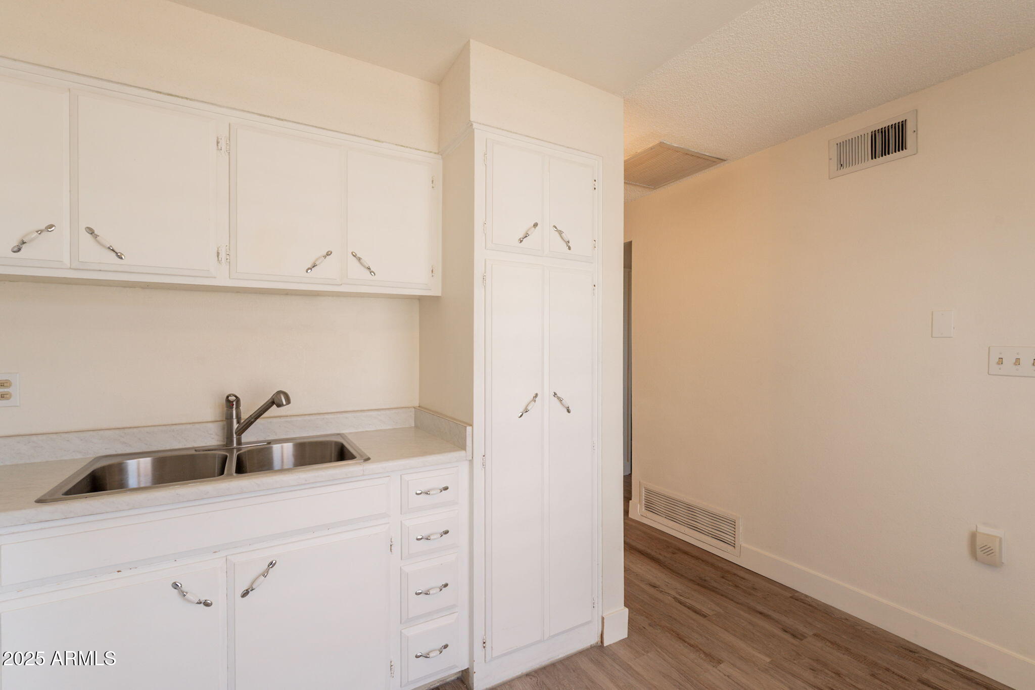 13001 North 113th Avenue, Unit 5 Youngtown, AZ 85363 - Photo 14 of 36 a kitchen with a sink and cabinets