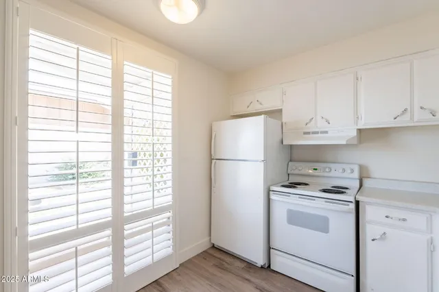 a kitchen with a white cabinets and white appliances
