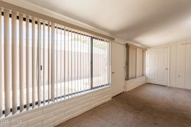 a view of an empty room and a window
