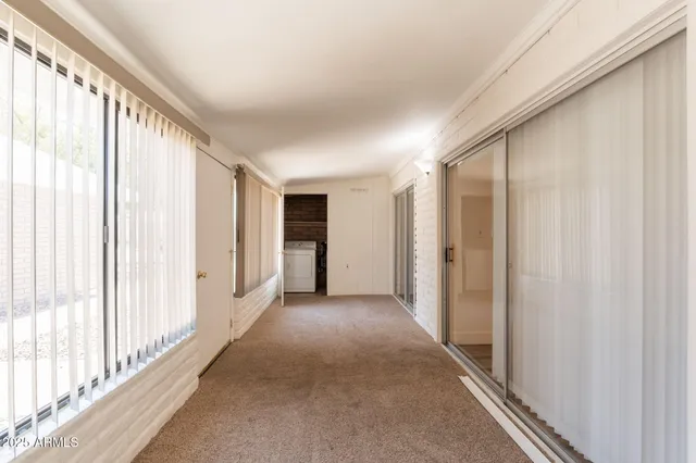 a view of a hallway with wooden shelves