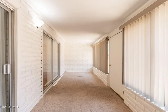 a view of a hallway with wooden floor and entryway