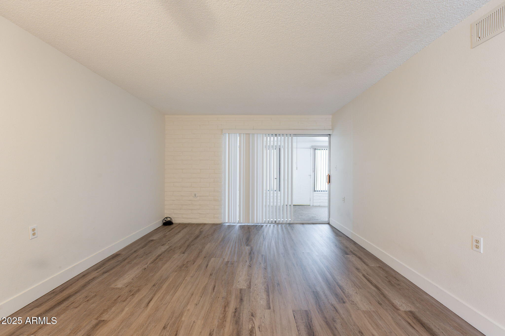 13001 North 113th Avenue, Unit 5 Youngtown, AZ 85363 - Photo 5 of 36 a view of an empty room and wooden floor