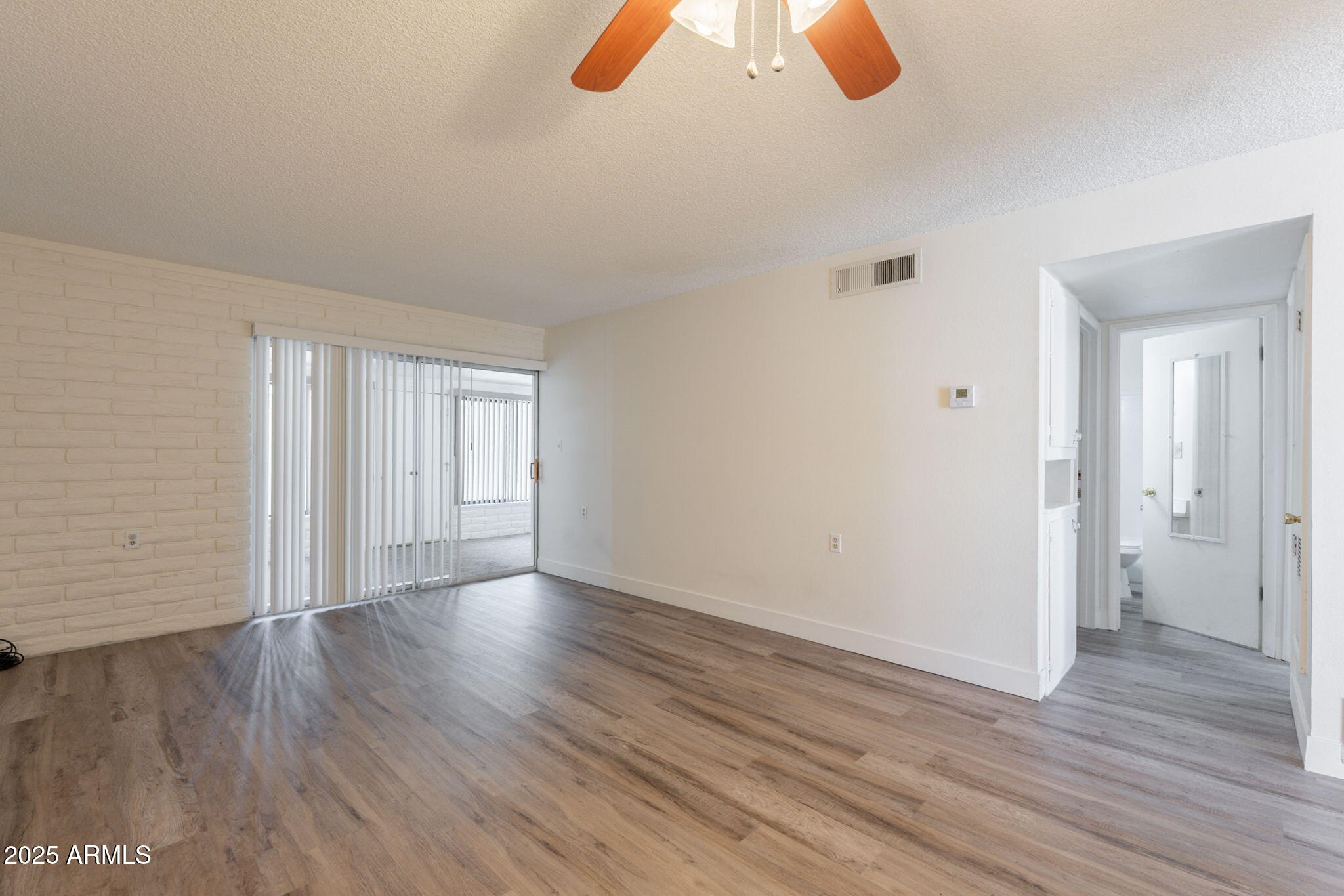 13001 North 113th Avenue, Unit 5 Youngtown, AZ 85363 - Photo 6 of 36 a view of an empty room and wooden floor