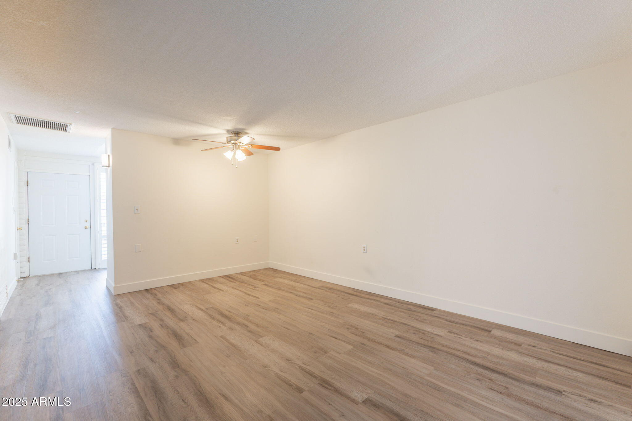 13001 North 113th Avenue, Unit 5 Youngtown, AZ 85363 - Photo 10 of 36 a view of a big room with wooden floor