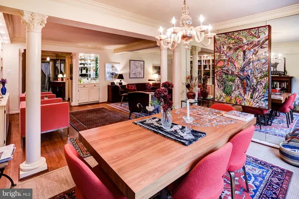 a living room with furniture a rug and a large window