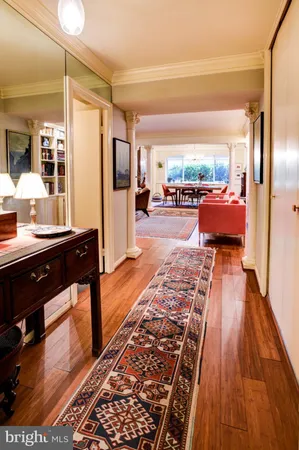 a living room with furniture a rug and a floor to ceiling window