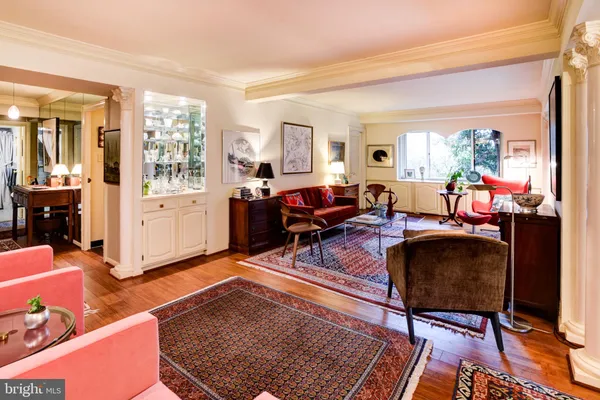 a living room with furniture a rug and a large window