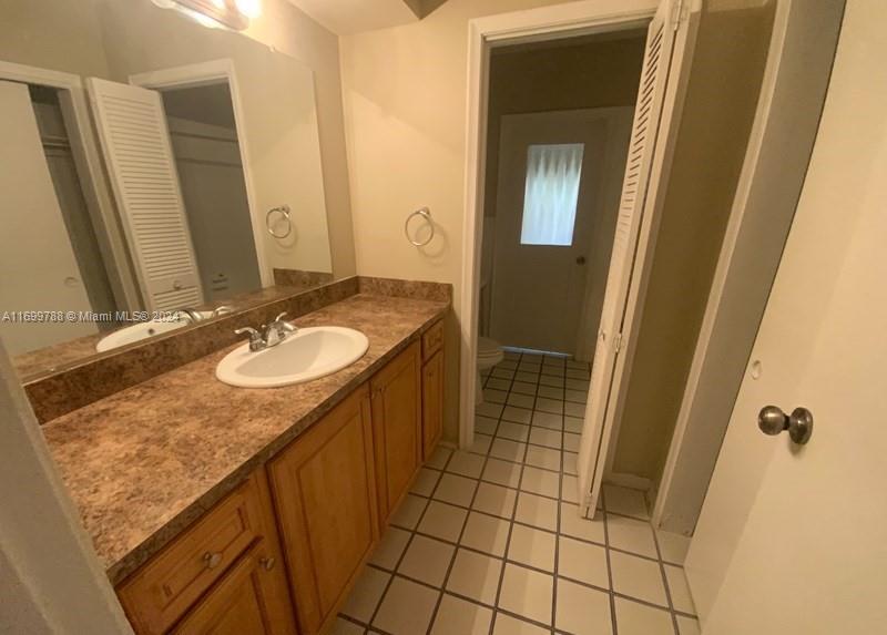 4308 Adams Street Hollywood, FL 33021 - Photo 12 of 21 a bathroom with a sink a mirror and shower