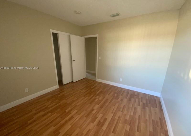 4308 Adams Street Hollywood, FL 33021 - Photo 14 of 21 a view of empty room with wooden floor