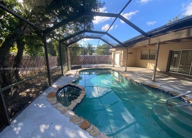 4308 Adams Street Hollywood, FL 33021 - Photo 21 of 21 a backyard of a house with yard table and chairs