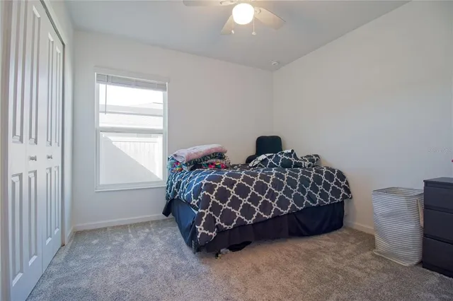 a bed sitting in a bedroom next to a window