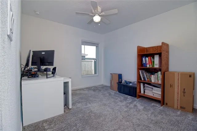 a view of room with workspace and windows