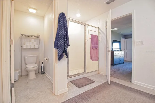 a bathroom with a toilet and a shower