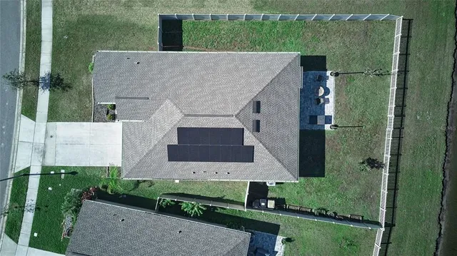 an aerial view of a house with a yard