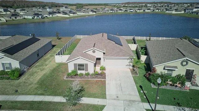 an aerial view of a house with a lake view